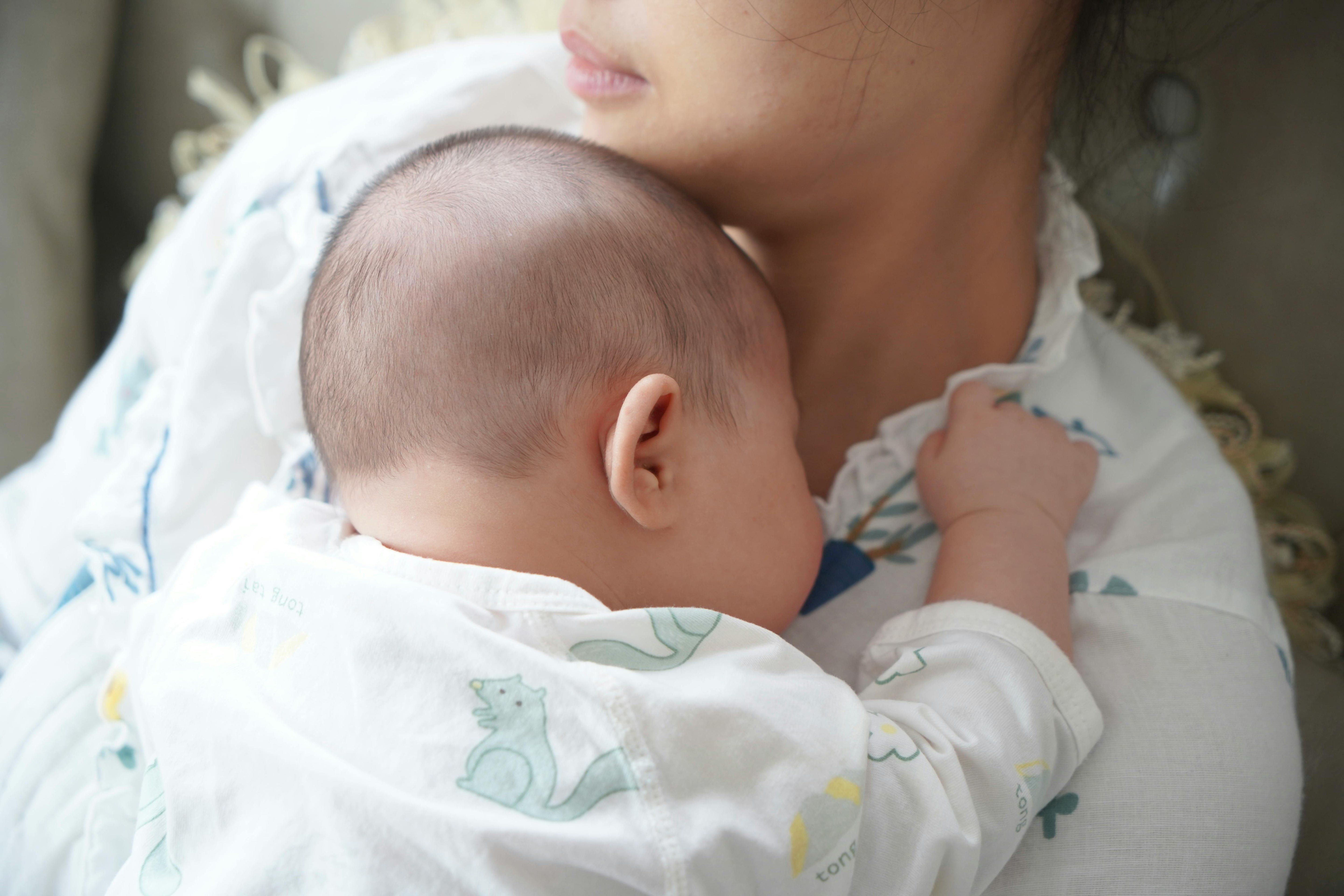 Newborn baby sleeping on mother's chest