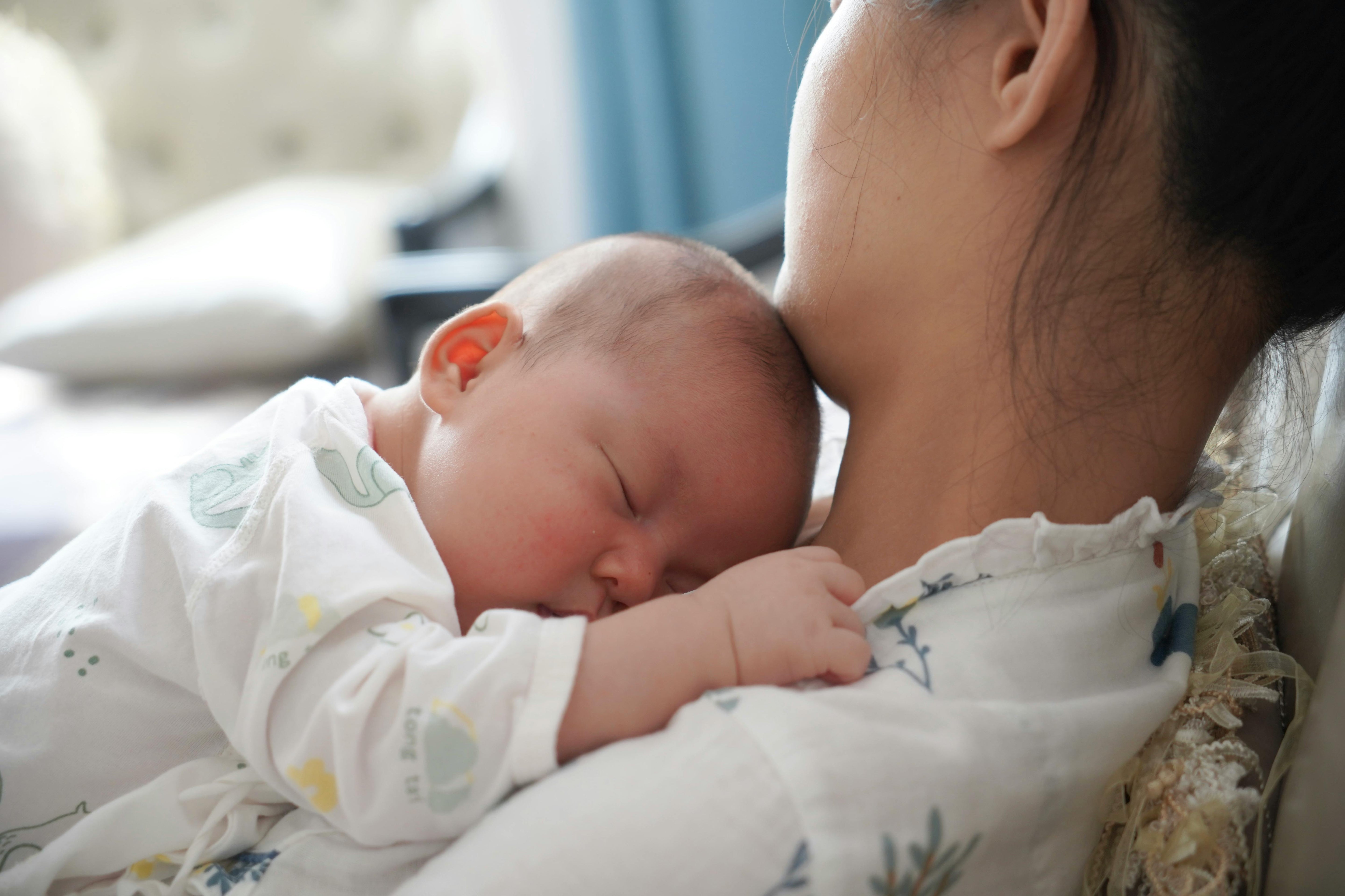 Mother lying with newborn baby on her chest