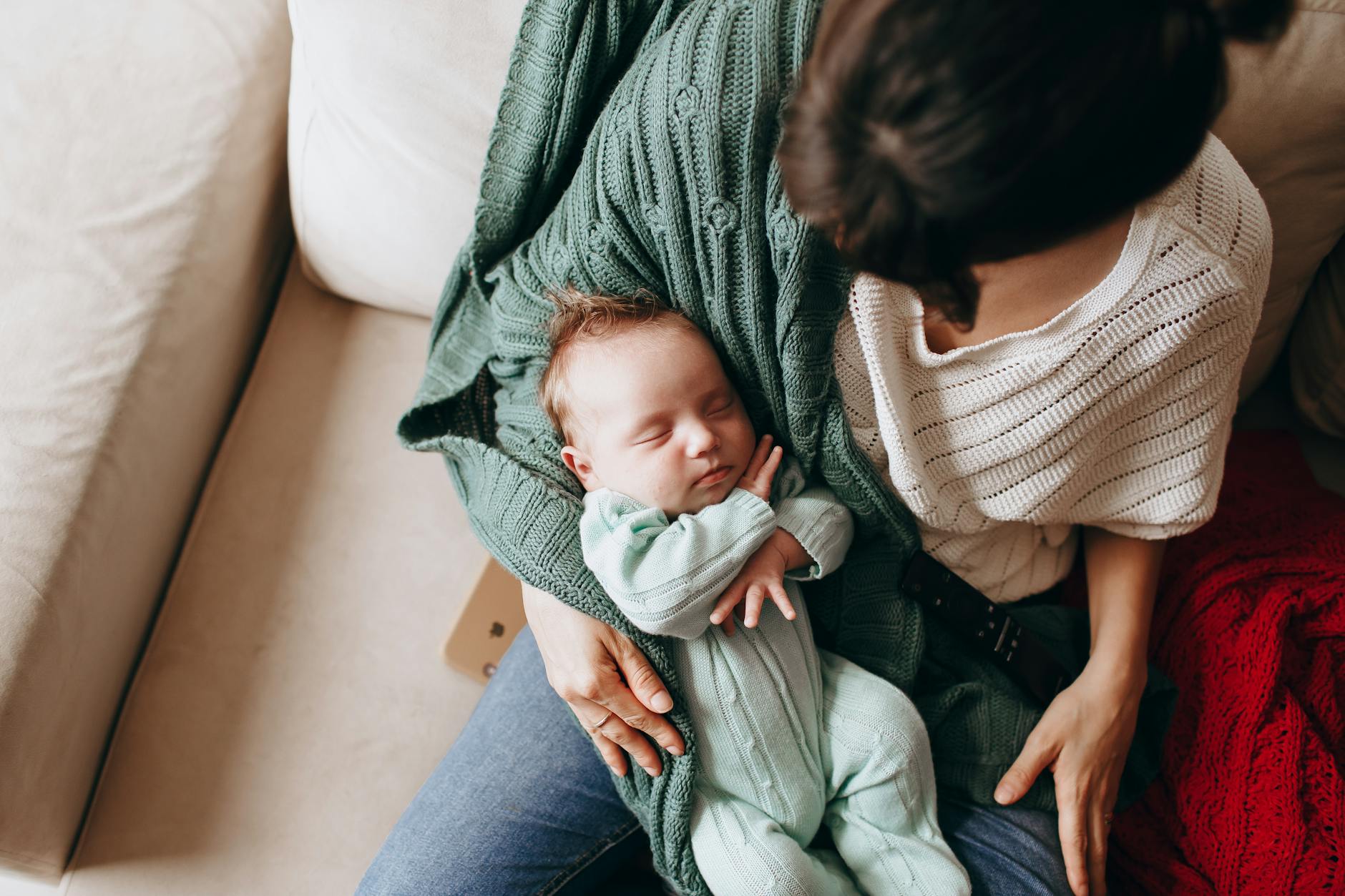 Mother holding her sleeping baby gently