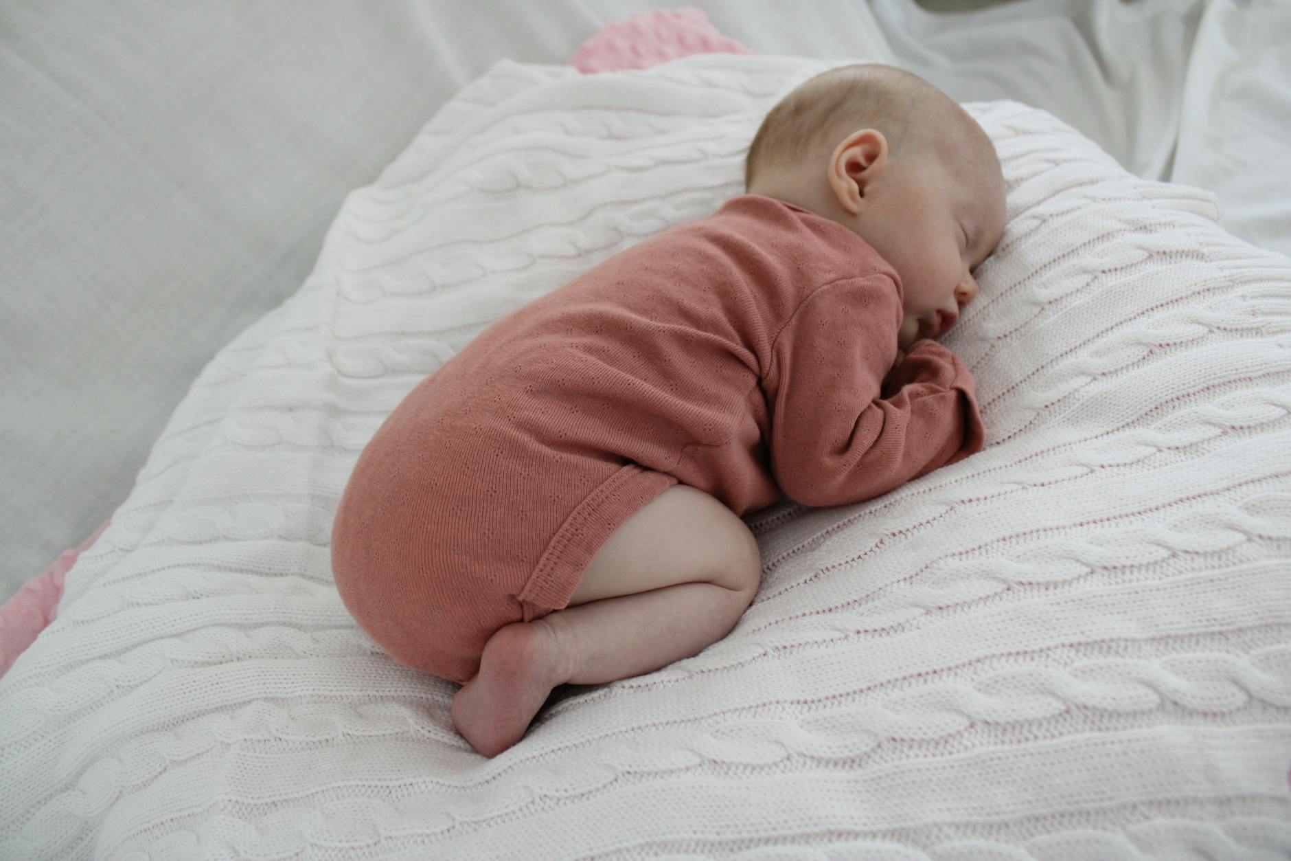 Sleeping baby resting peacefully on a soft blanket
