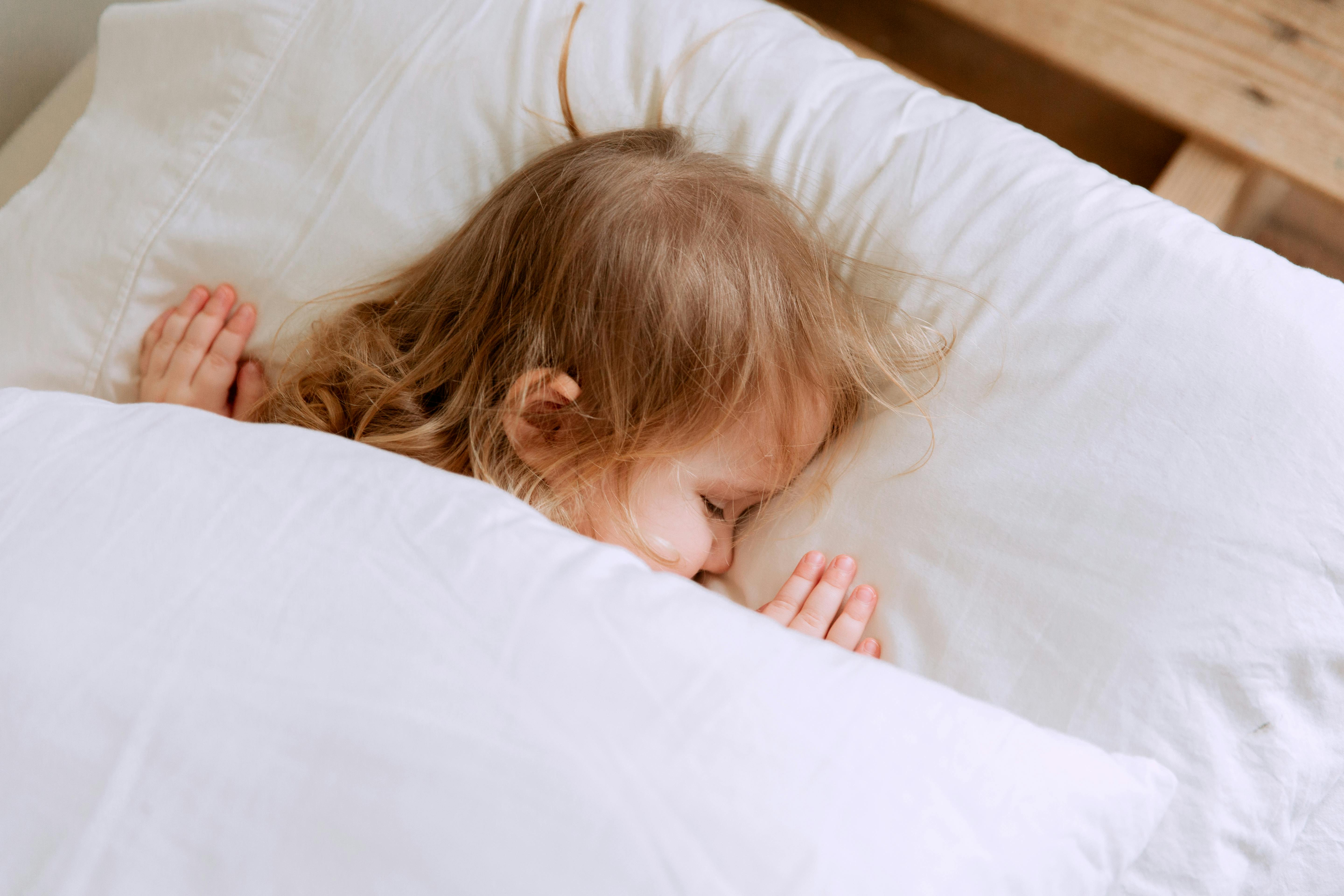 Young child peacefully sleeping in bed