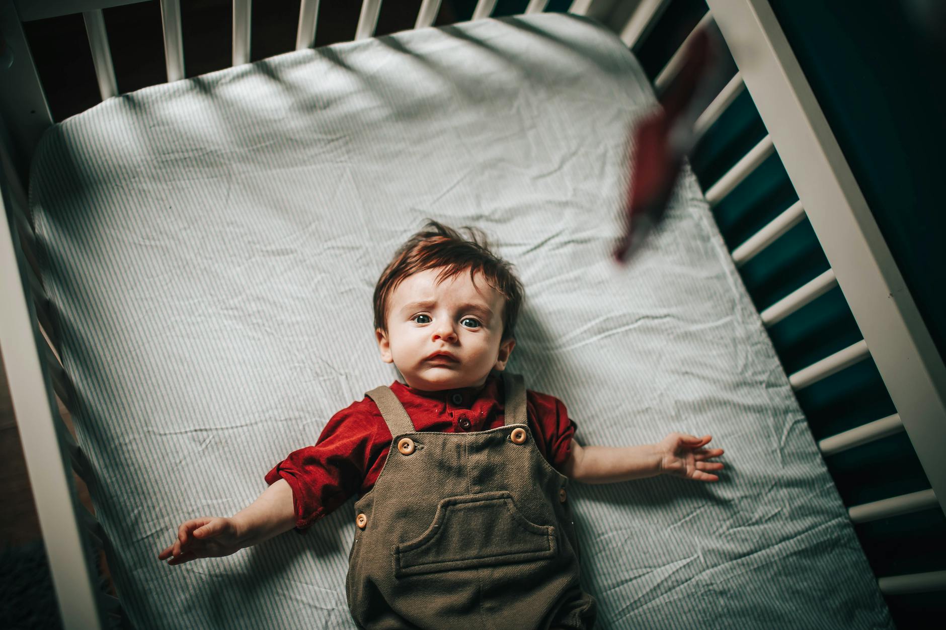 Baby resting in their crib