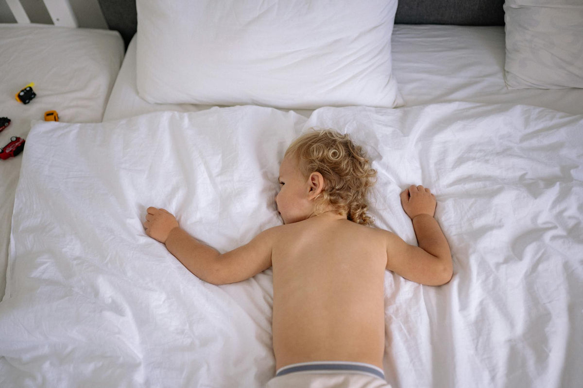 Toddler resting peacefully in bed